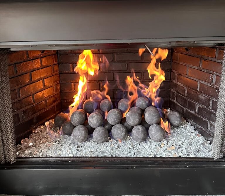 Projects gas fireplace with geospheres and white fire glass bed in Frisco Texas