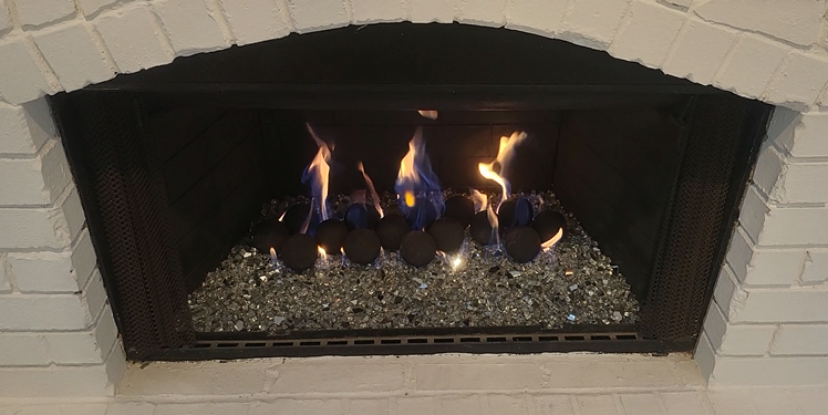 Projects gas fireplace serviced and installed geospheres with black and white fireglass ins Flower Mound Texas