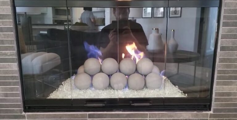 Projects gray geospheres with white fire glass and custom glass doors installation in Frisco Texas
