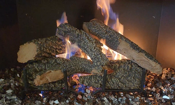 Projects gas fireplace service and split oak gas log set install with black copper fire glass in Denton Texas